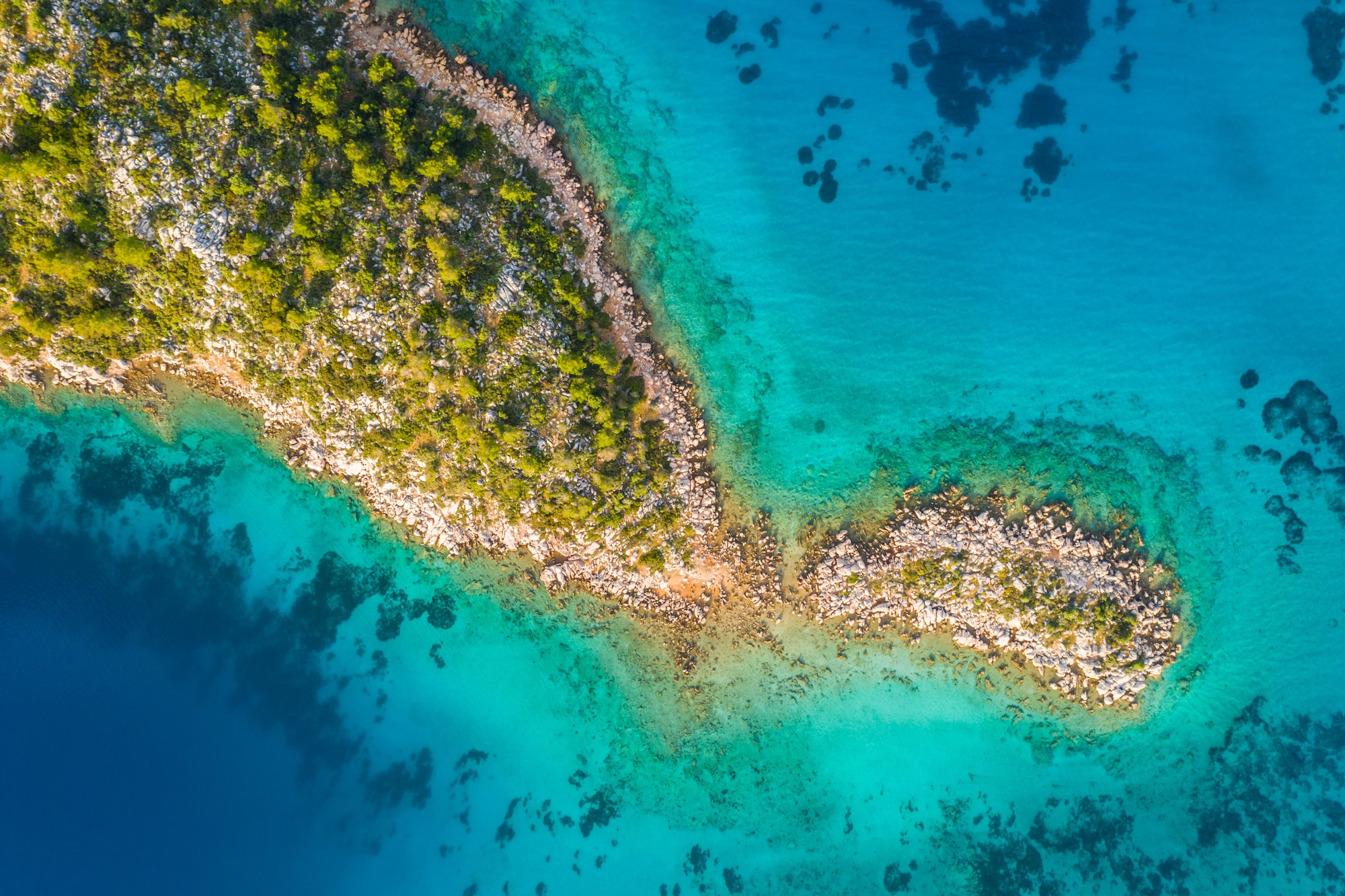 Aerial view of clear turquoise water near a tropical island in the Caribbean
